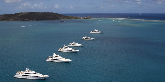 The Westport Rendezvous Cruise in Company motor yachts pose for their photoshoot in front of Mosquito Island